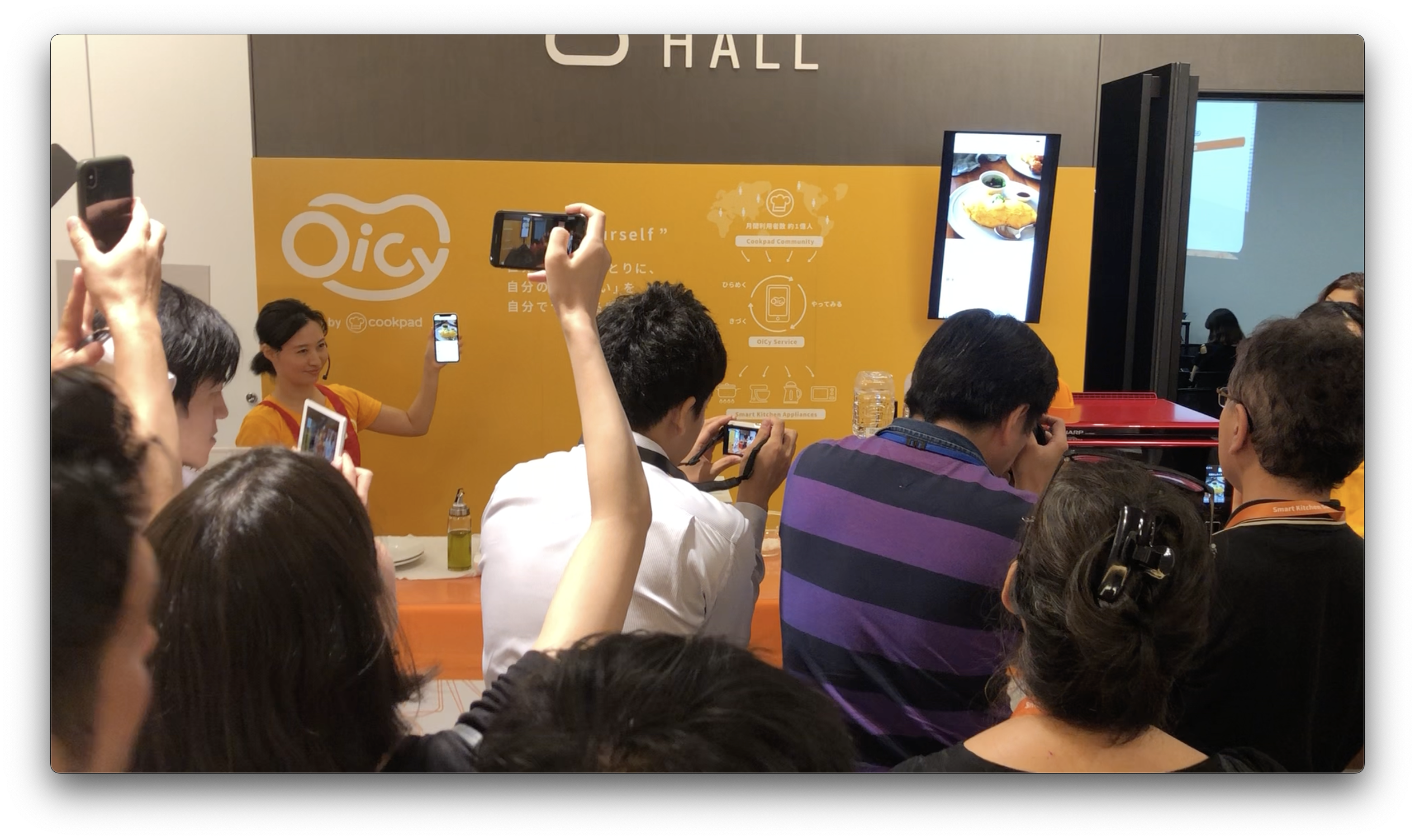 A video still from the OiCy Smart Kitchen Summit Japan 2019 presentation showing a hardware-integrated recipe app prototype.